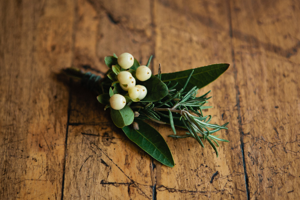 Winter boutonniere with berries and rosemary.