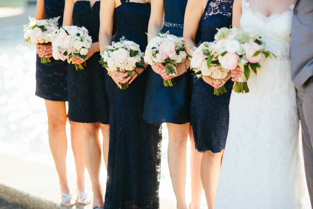 Wedding party bouquets. Navy dresses, white and blush flowers.
