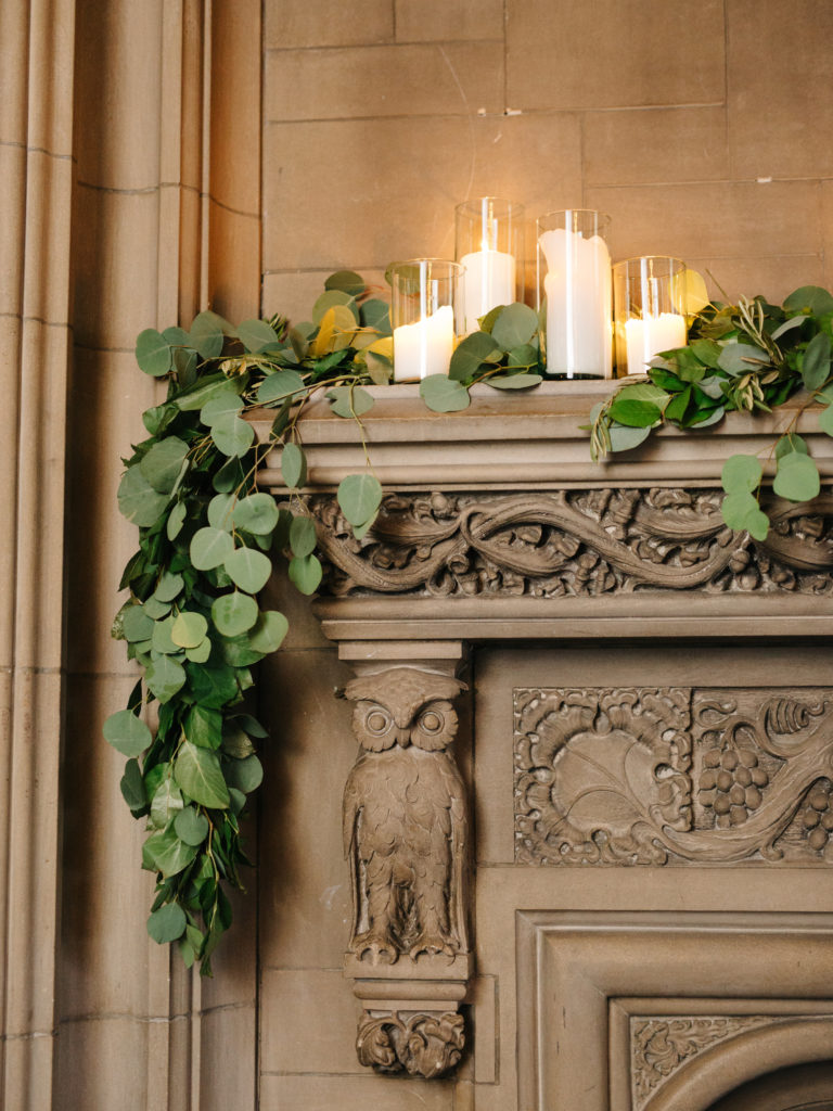 University Club of Chicago fireplace mantel with garland and candles.