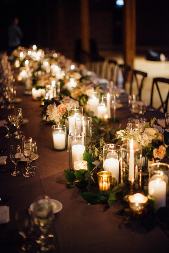 Flowers by Pollen. Photography by Tim Tab Studios. Head table with garland and candles.