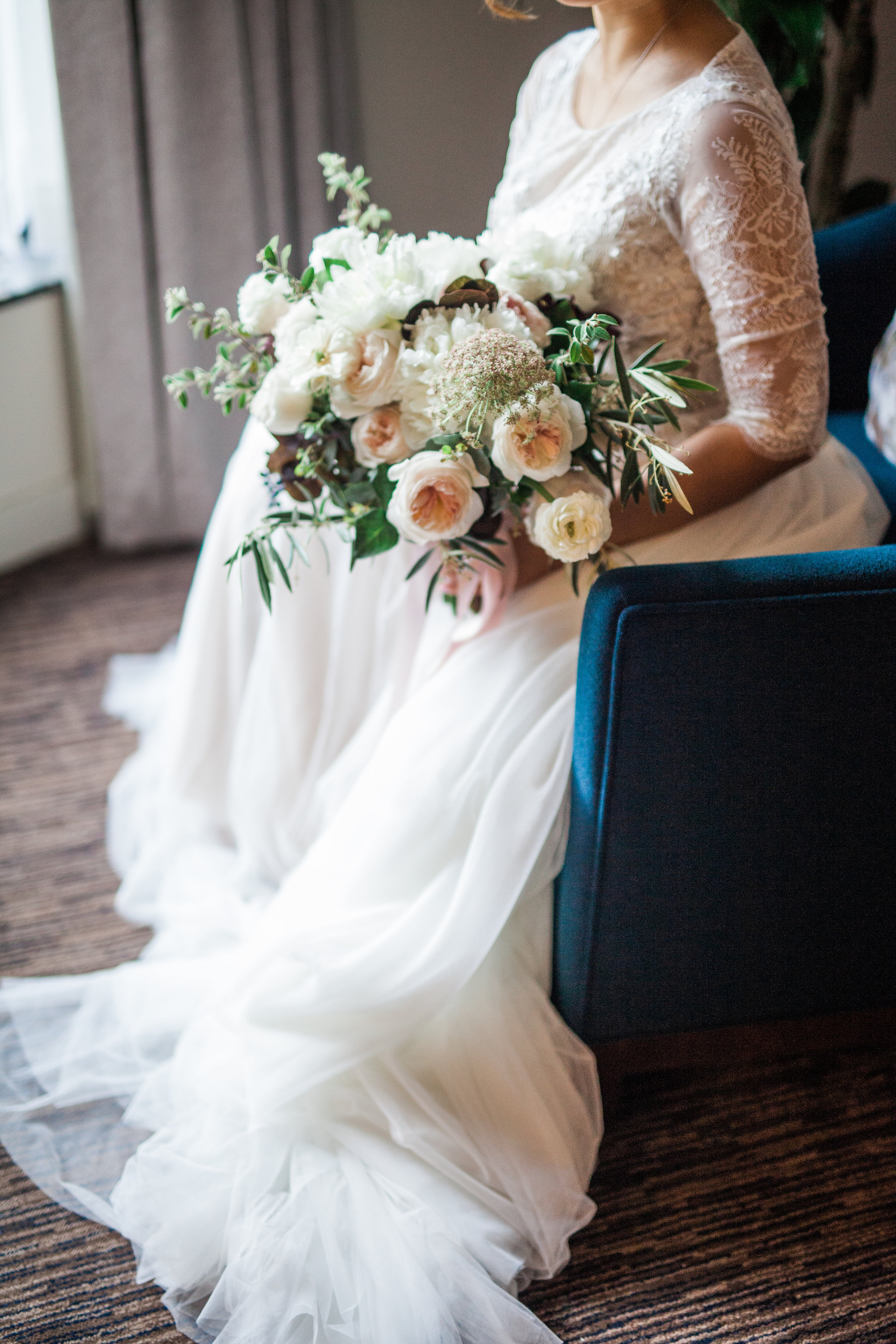 seated bride with spring bouquet