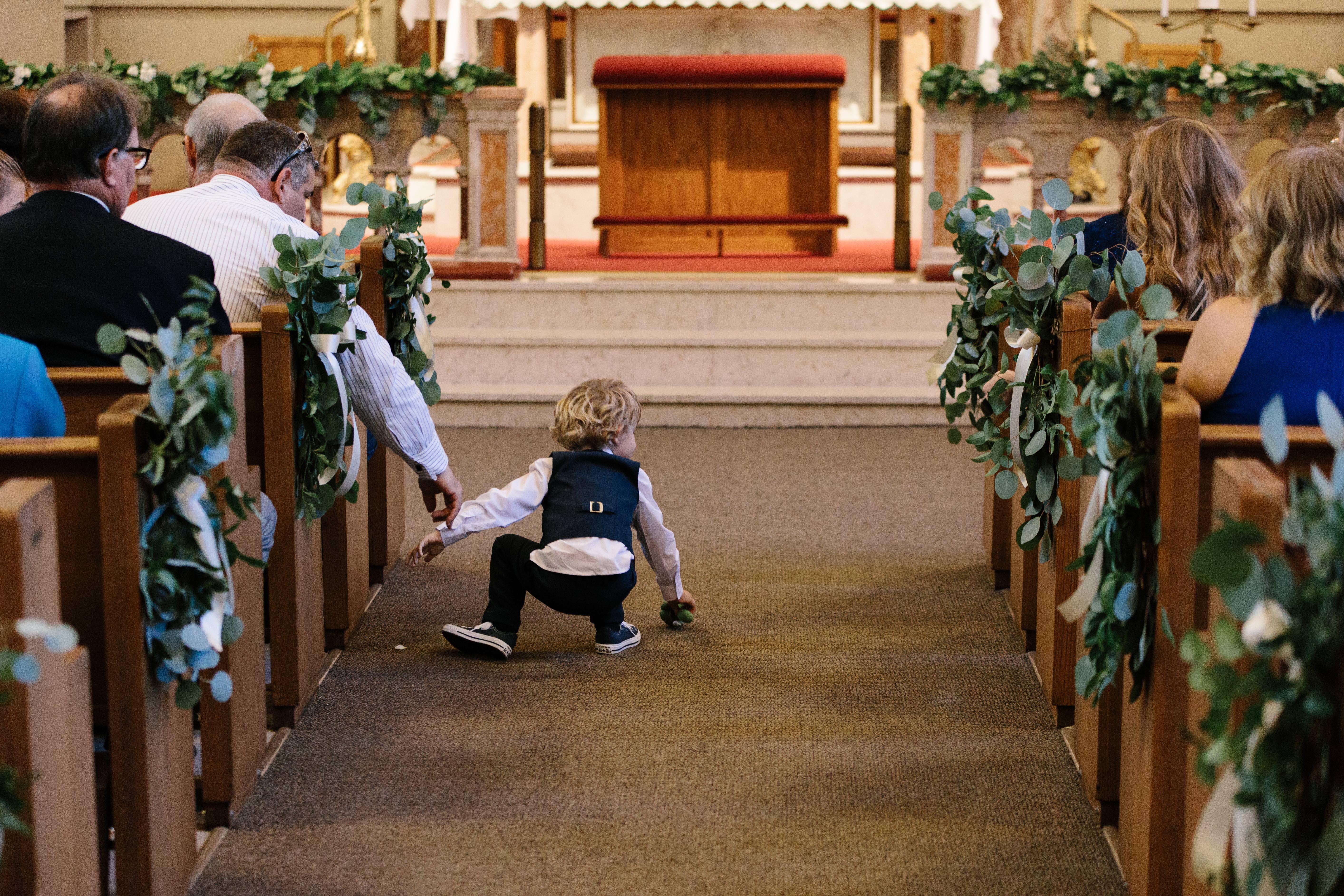 ring bearer, pew swags, and garland at Assumption Catholic Church in Chicago