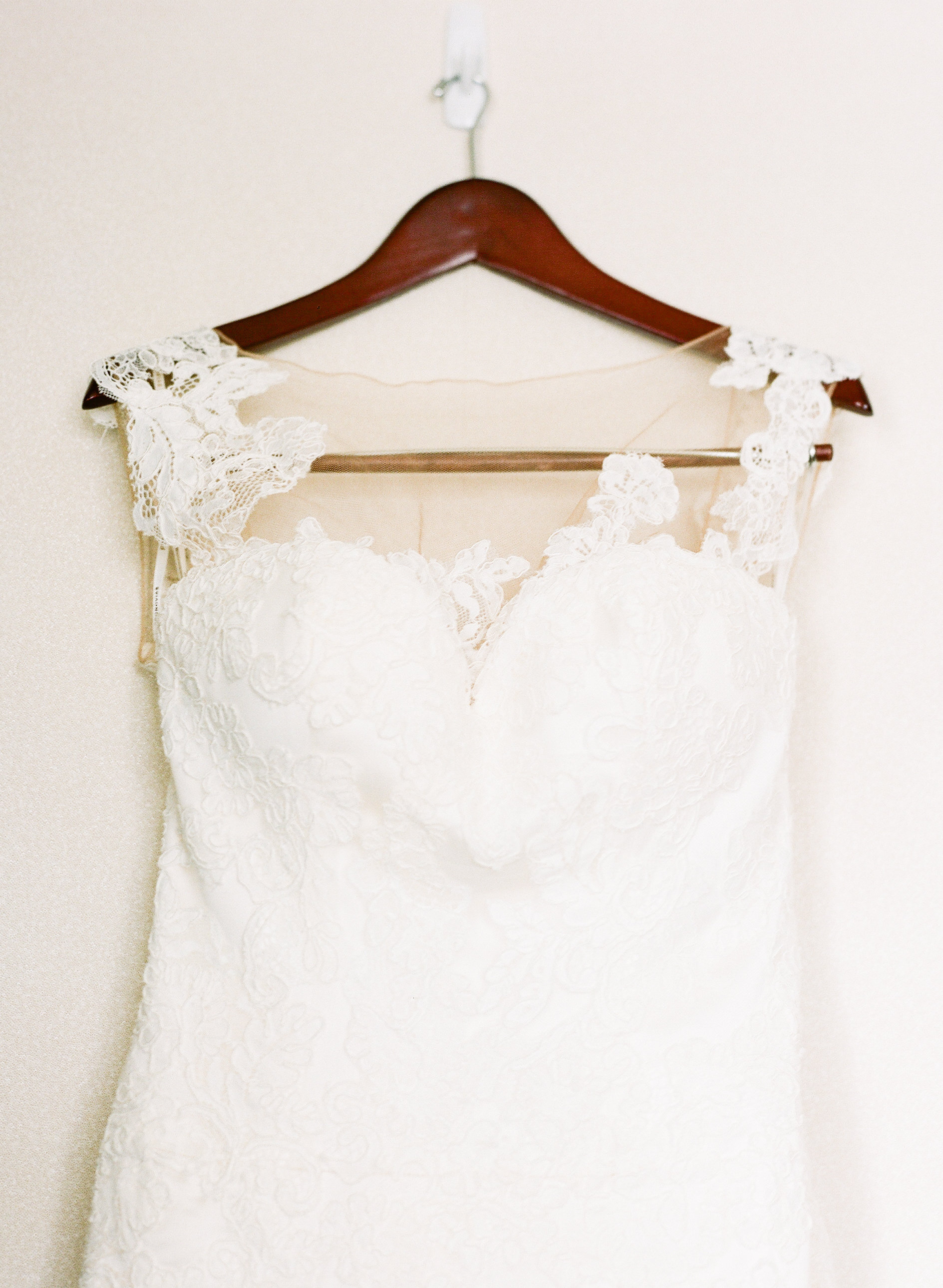 Wedding dress on wooden hanger.