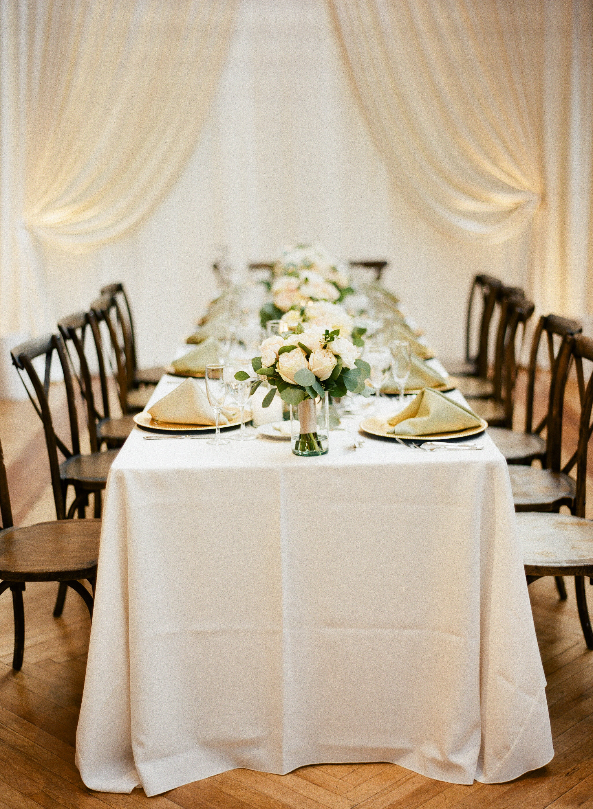 White table and floral bouquets for wedding venue at Bridgeport Skyline Loft. 
