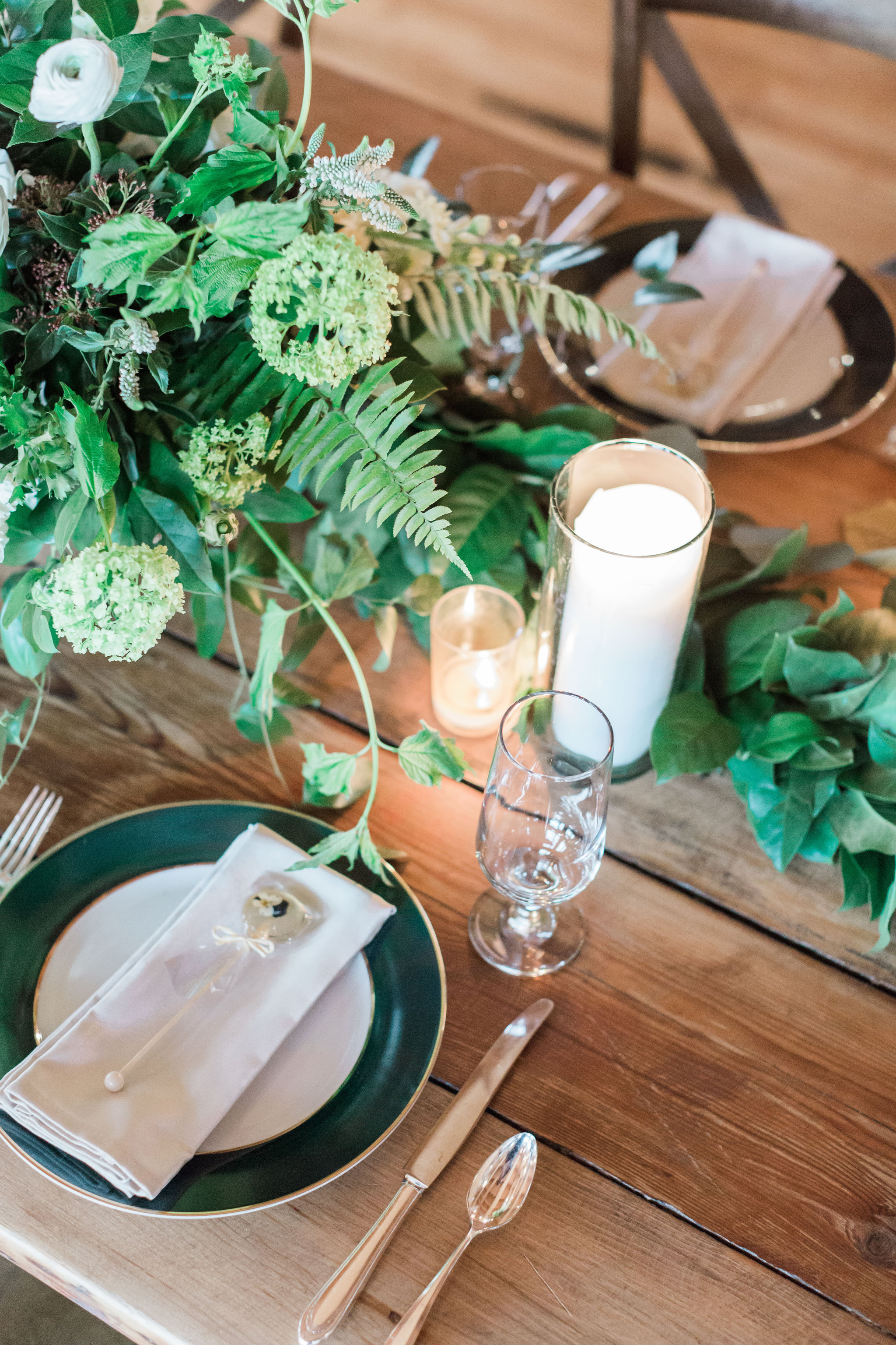 Farm table decorated in green and white for a winter wedding.