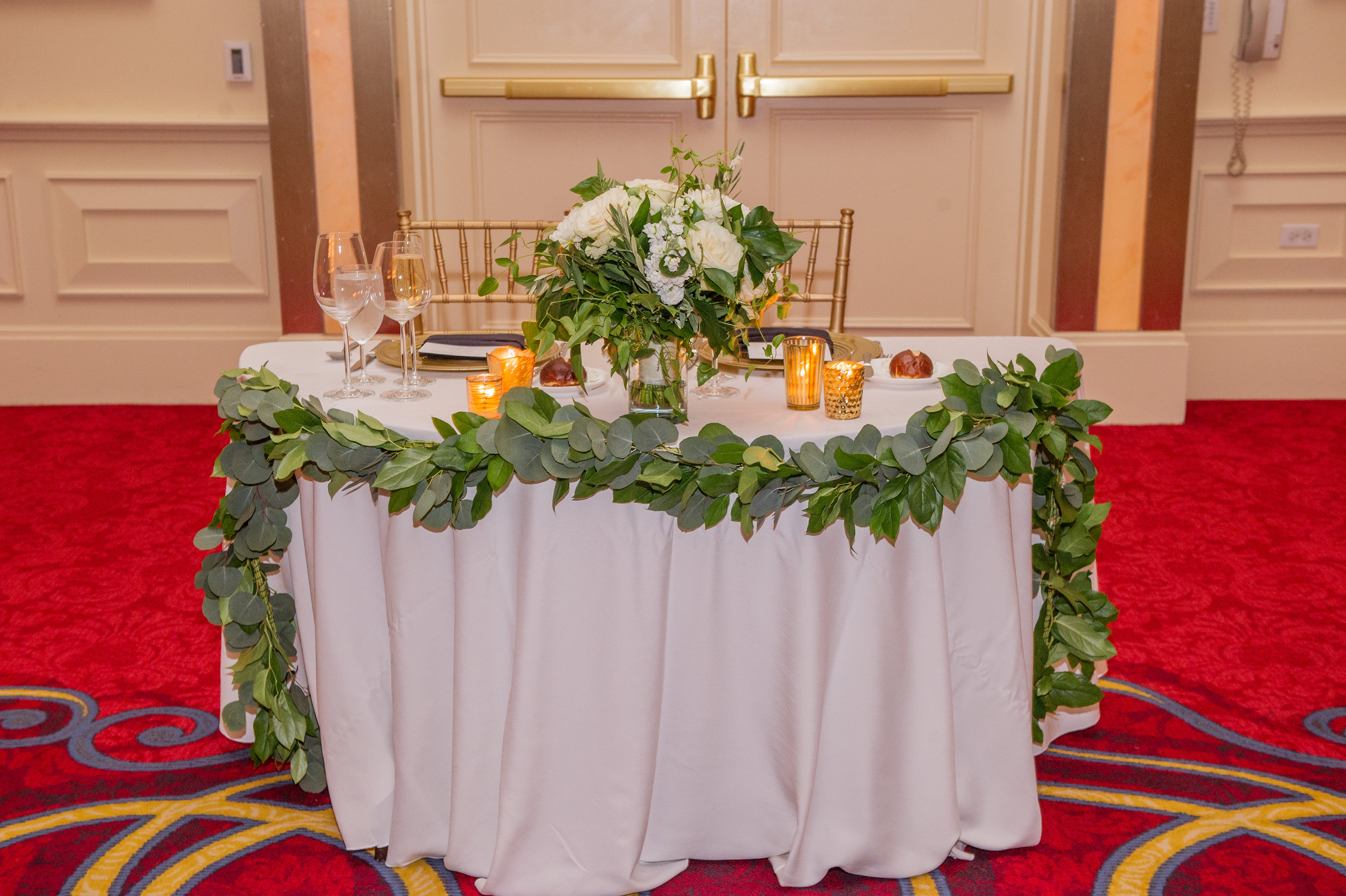 JW Marriott Chicago autumn wedding sweetheart table with ivory and green arrangment.