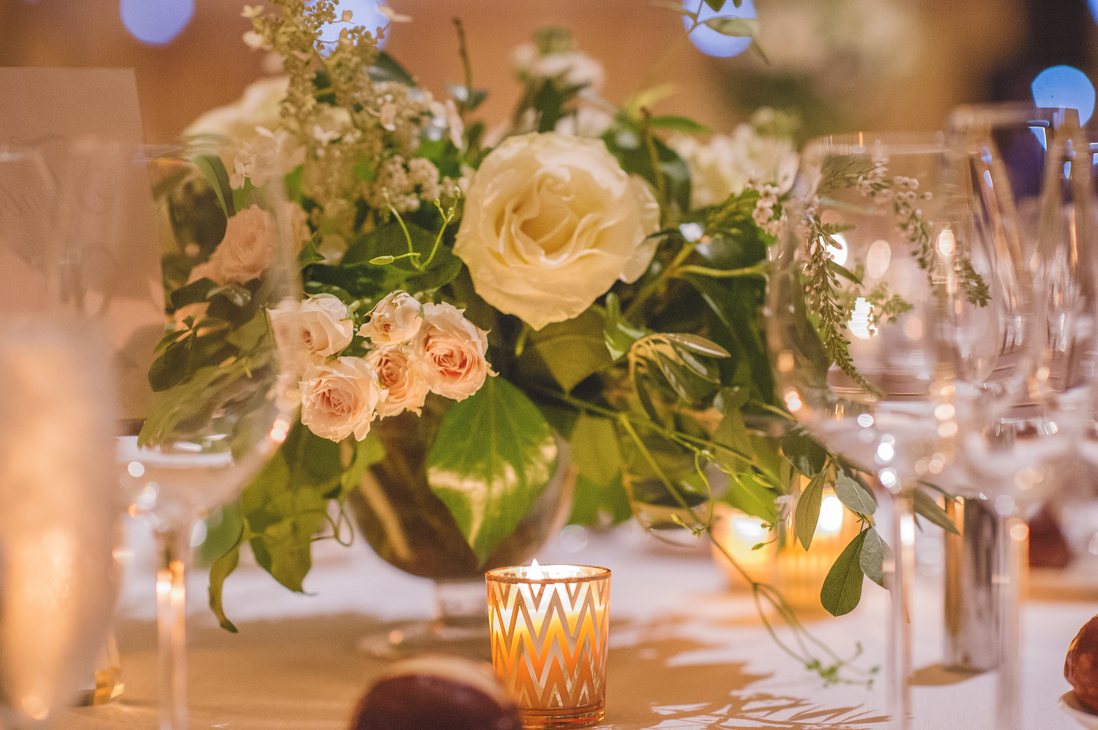 Autumn wedding reception room with classic ivory and blush arrangements with garden roses at JW Marriott Chicago.