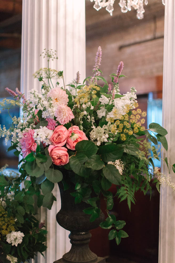 Lush summer wedding altar bouquet with dahlias, garden roses, fern, and hydrangea.