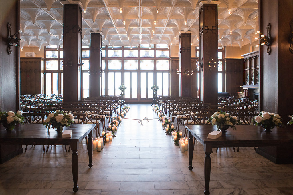 Chicago Athletic Association spring wedding with white arrangements and candlelit aisle.