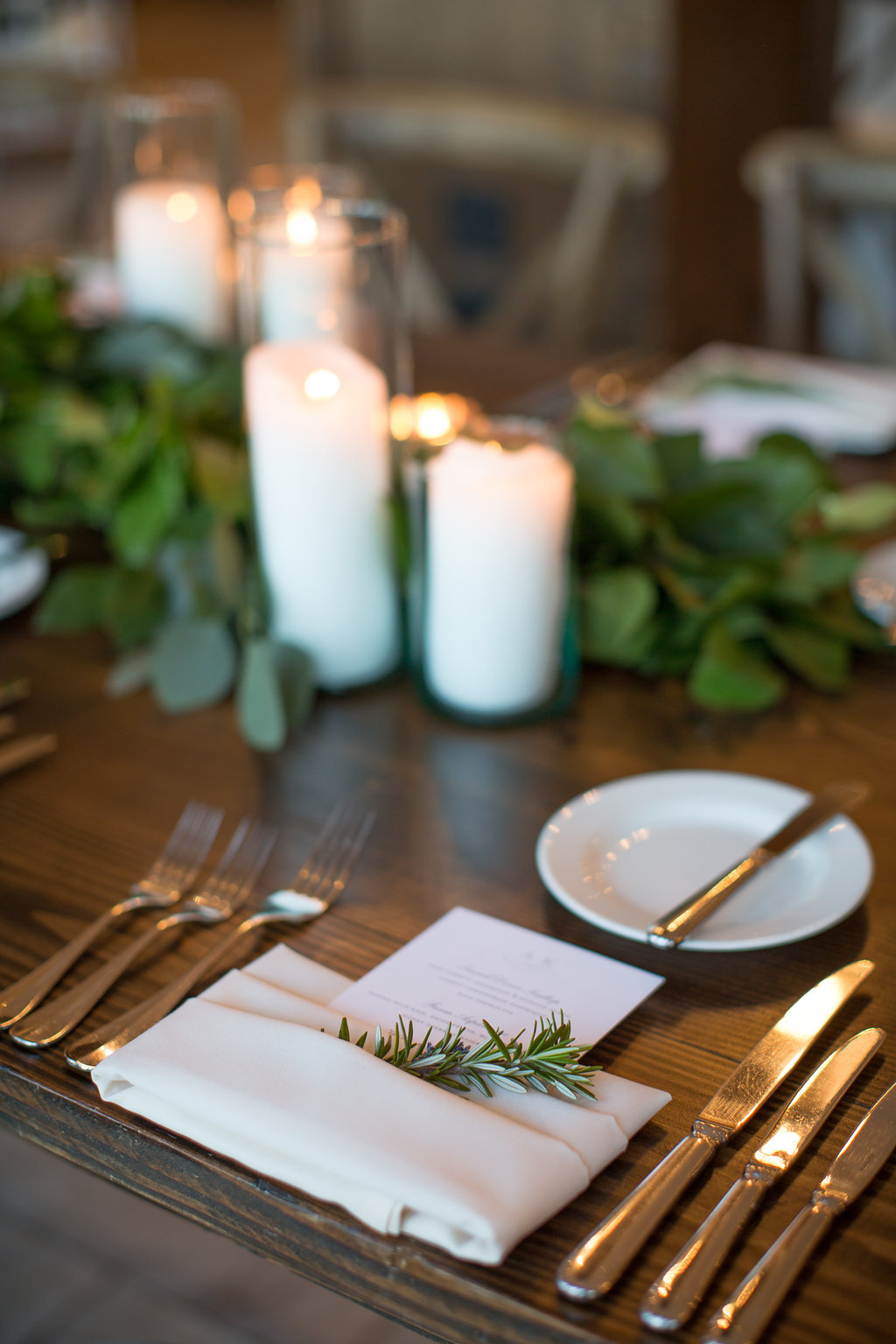 Details of spring wedding reception at Chicago Athletic Association with foliage, candles, and rosemary.