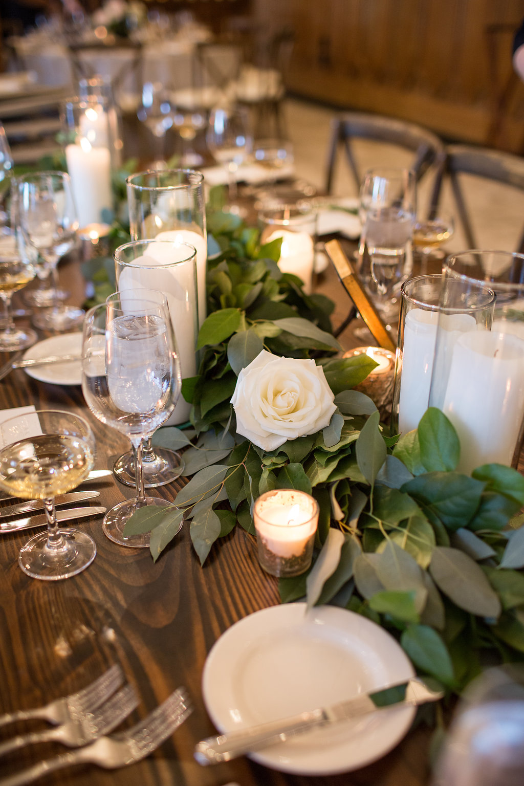 Chicago Athletic Association spring wedding reception with foliage garland and pillar candles.