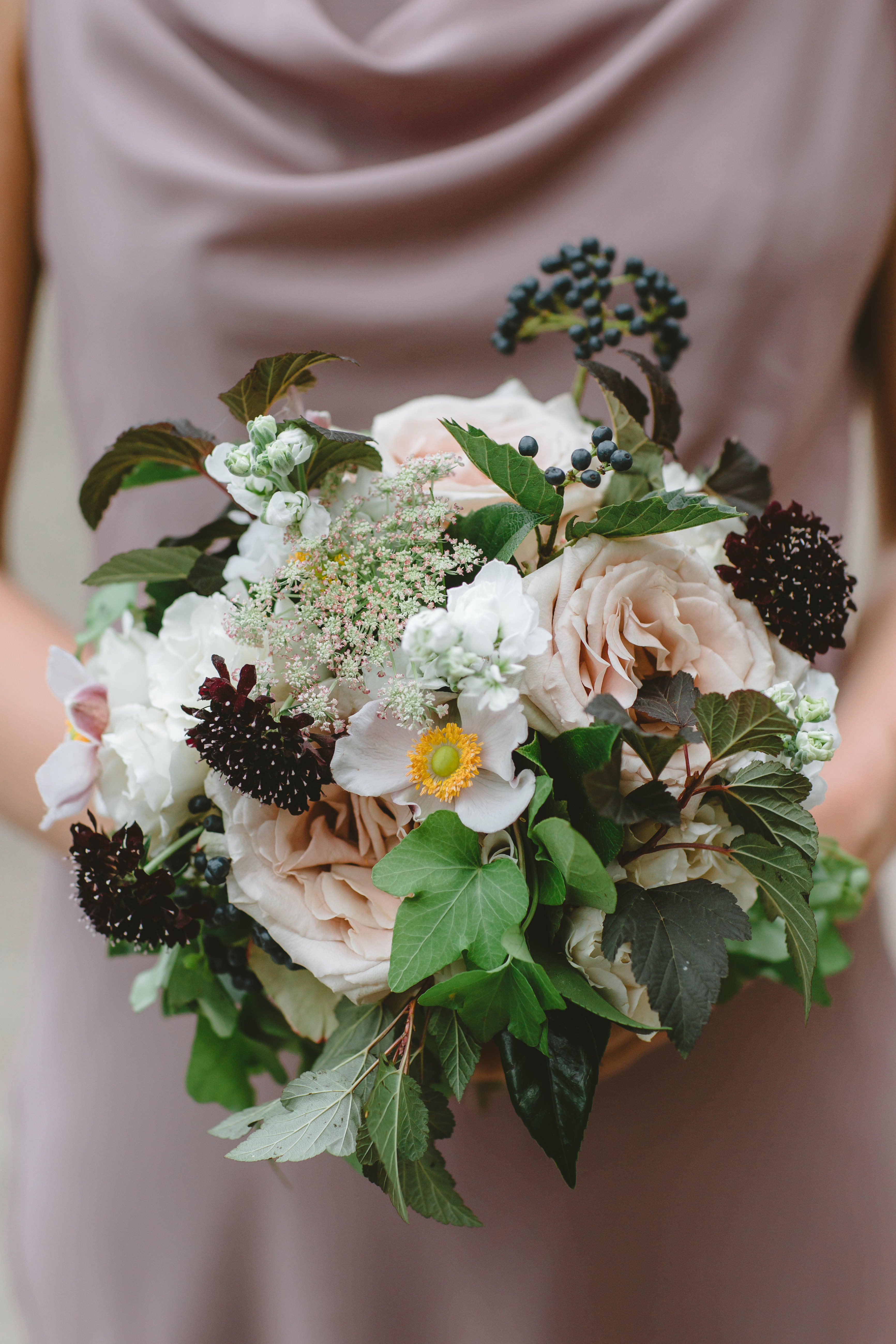Summer bridesmaid bouquet and Jenny Yoo dress in fig. Bouquet flowers in blush, burgundy, navy, green, white, and mauve.