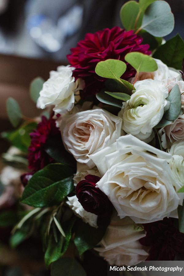 burgundy dahlias, blush garden roses, and ivory ranunculus for October wedding in Chicago.