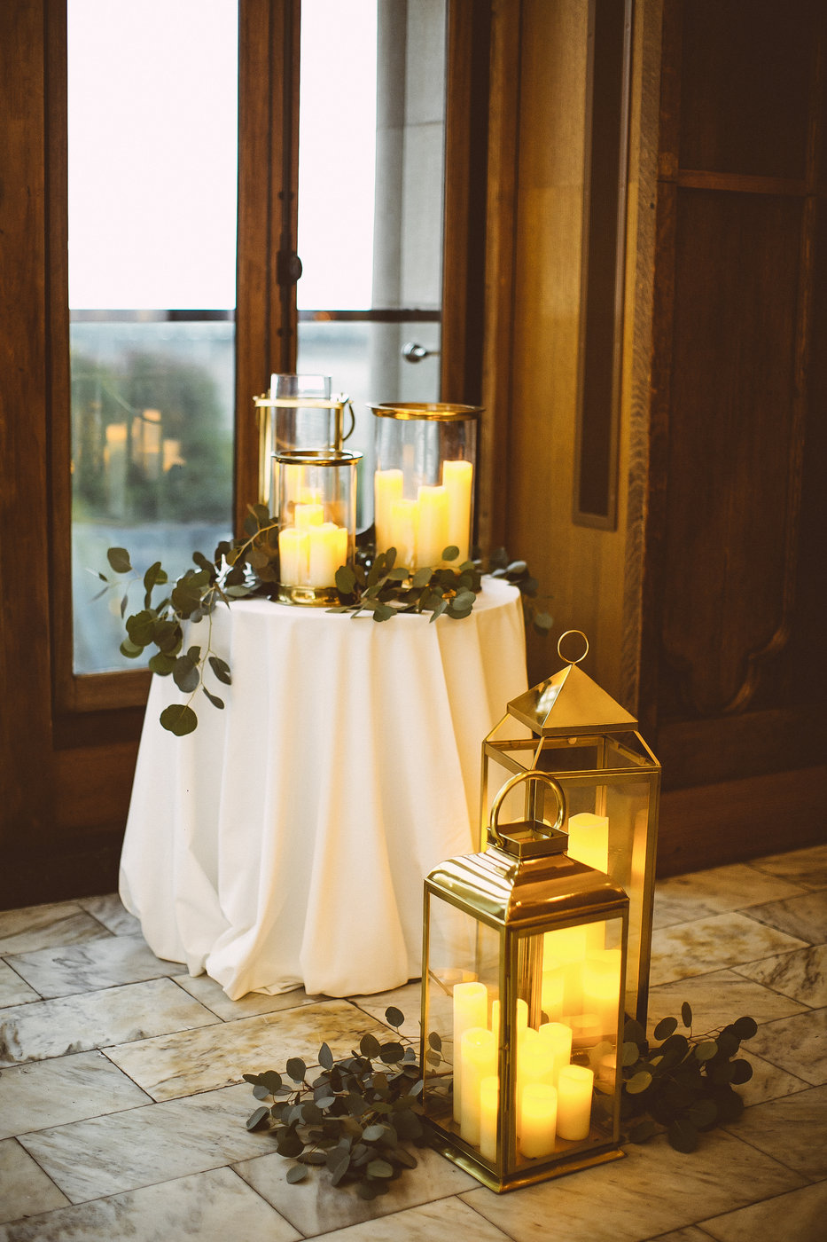 Ceremony details of brass lanterns with sprigs of eucalyptus for a class wedding at Chicago Athletic Association.