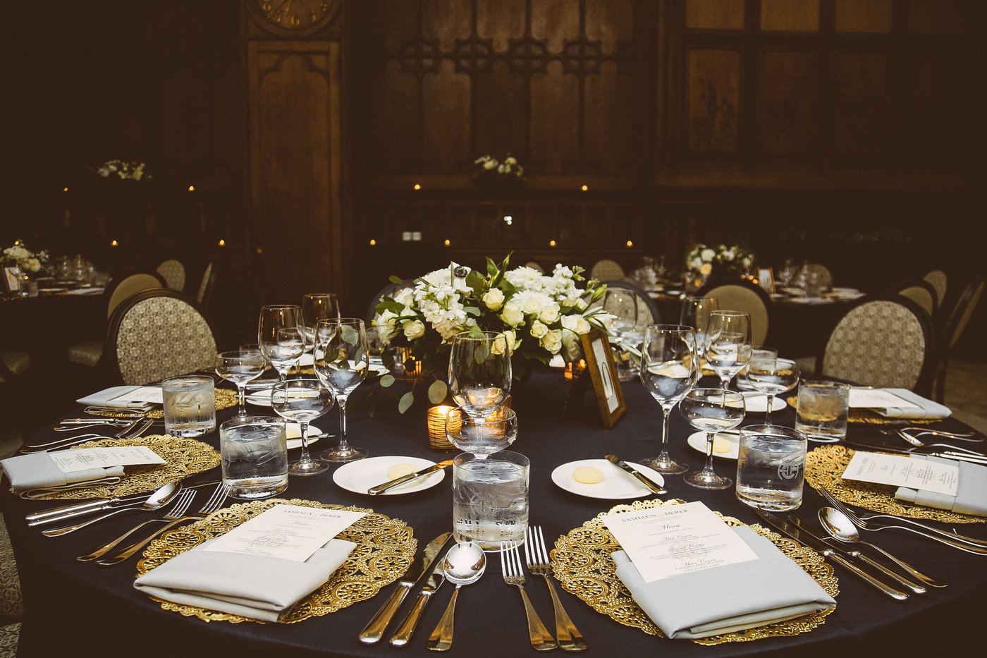 Reception at Chicago Athletic Association with monochromatic arrangements, navy and gold detail for an October wedding.