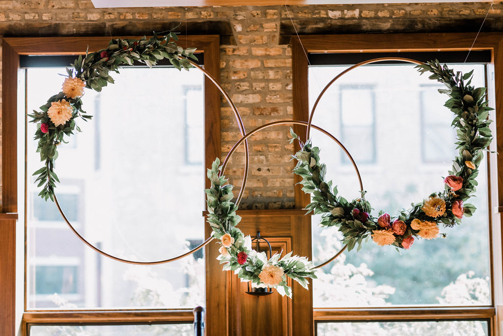 Whimsical wedding floral hoops for ceremony at Revolution Brewing Chicago with garden roses and dahlias.