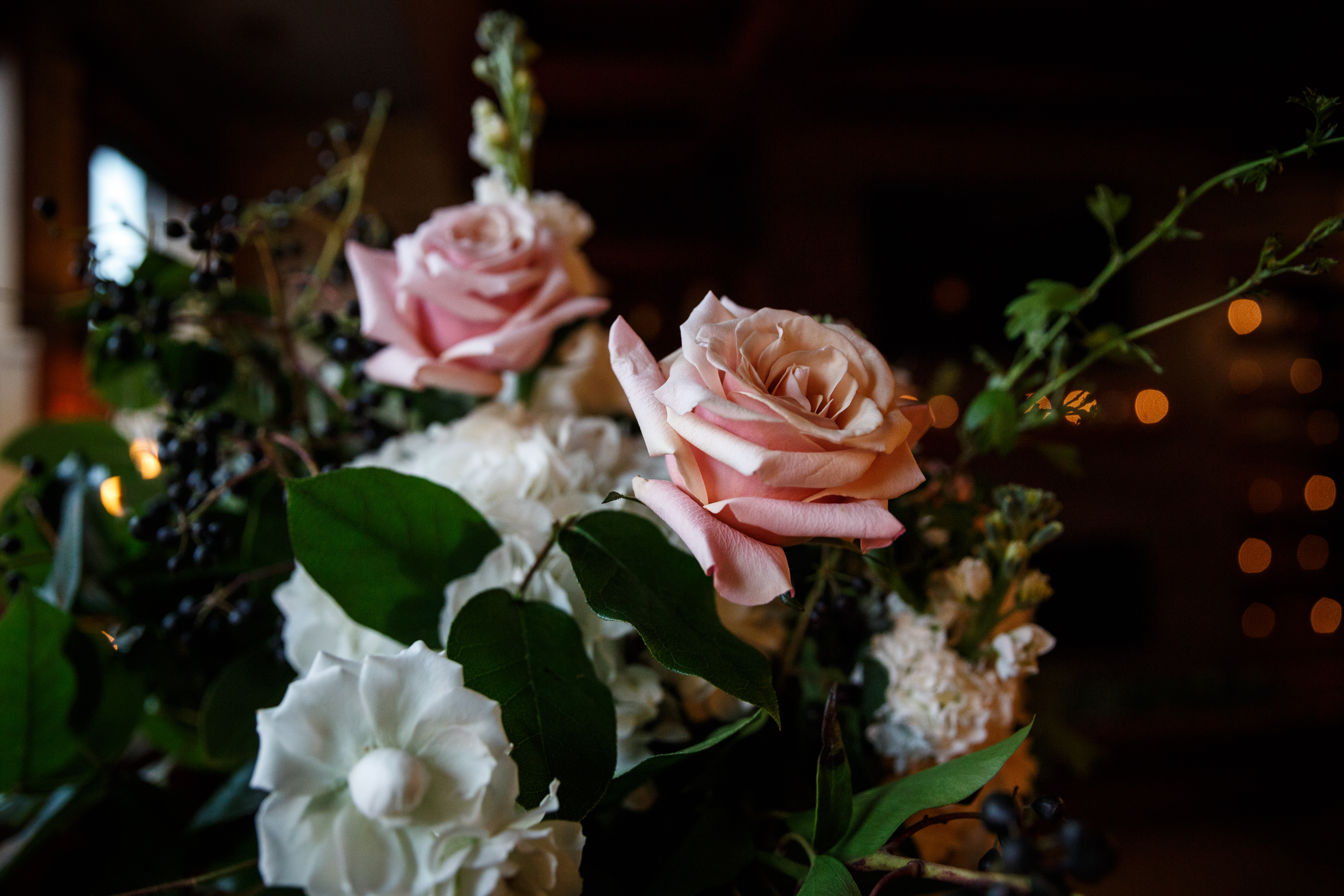 Pink garden roses at March wedding ceremony. Both arrangements were in clear glasses vases on Revolution Brewings wooden barrels as pedestals.