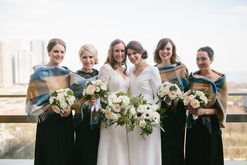 Winter bridal party white and blush bouquets, Irish wool shawls, and black dresses.