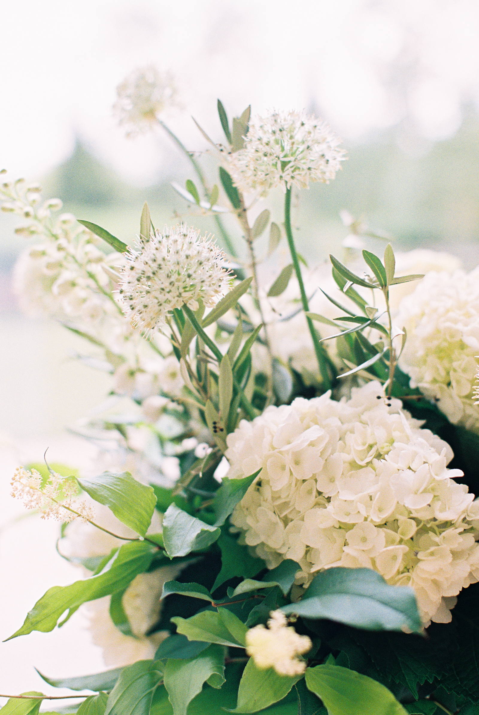 Altar flowers detail with white hydrangea and eucalyptus for monochromatic and minimalist wedding at Greenhouse Loft.