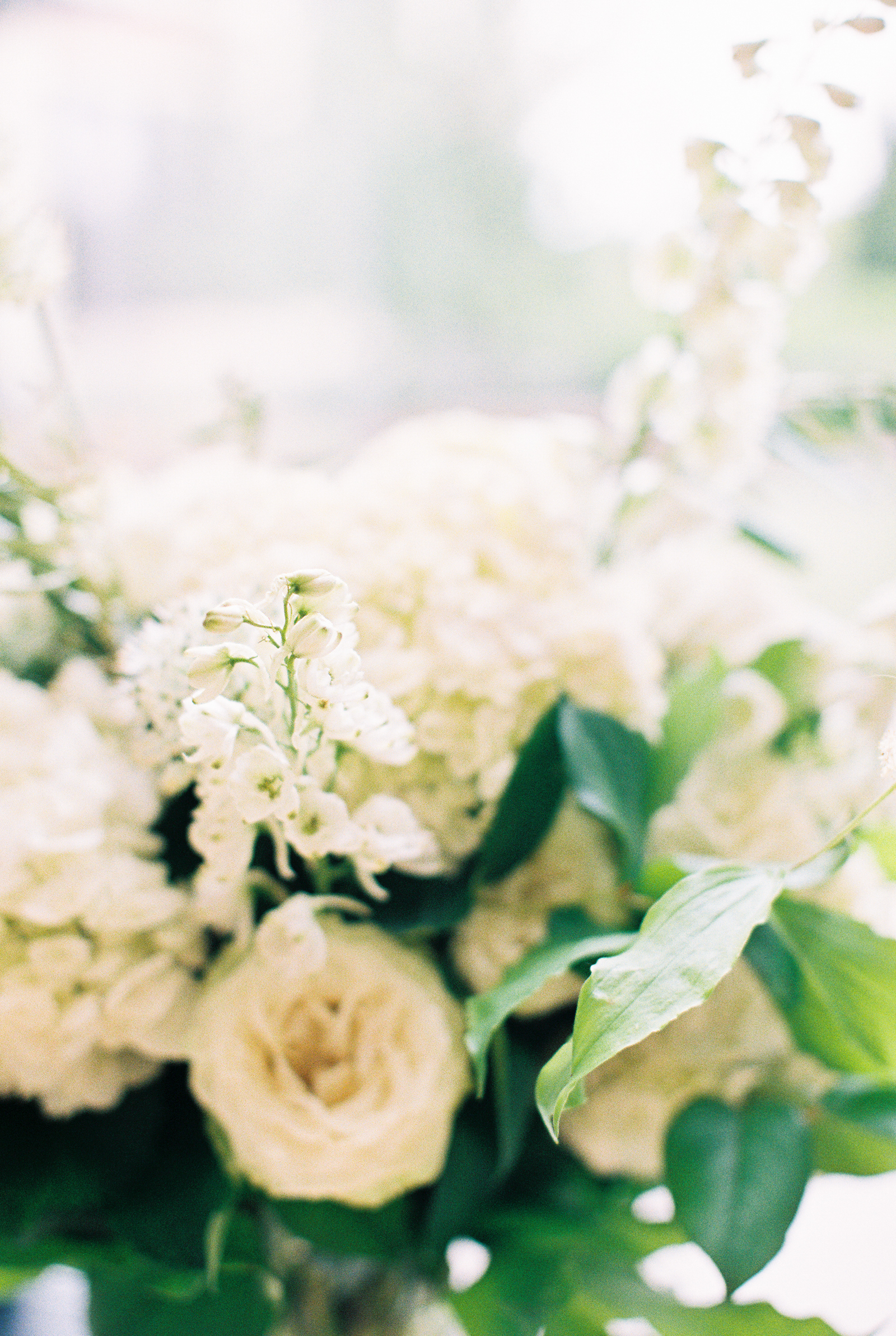 Altar flowers detail with white hydrangea and eucalyptus for monochromatic and minimalist wedding at Greenhouse Loft.