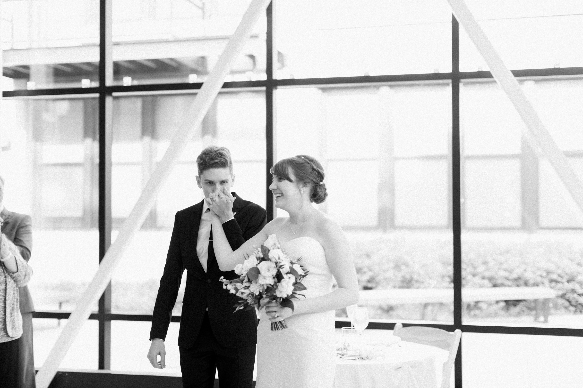 Smiling bride and groom in black and white for Greenhouse Loft minimalist wedding ceremony.