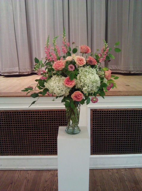 Summer wedding ceremony floral arrangement.