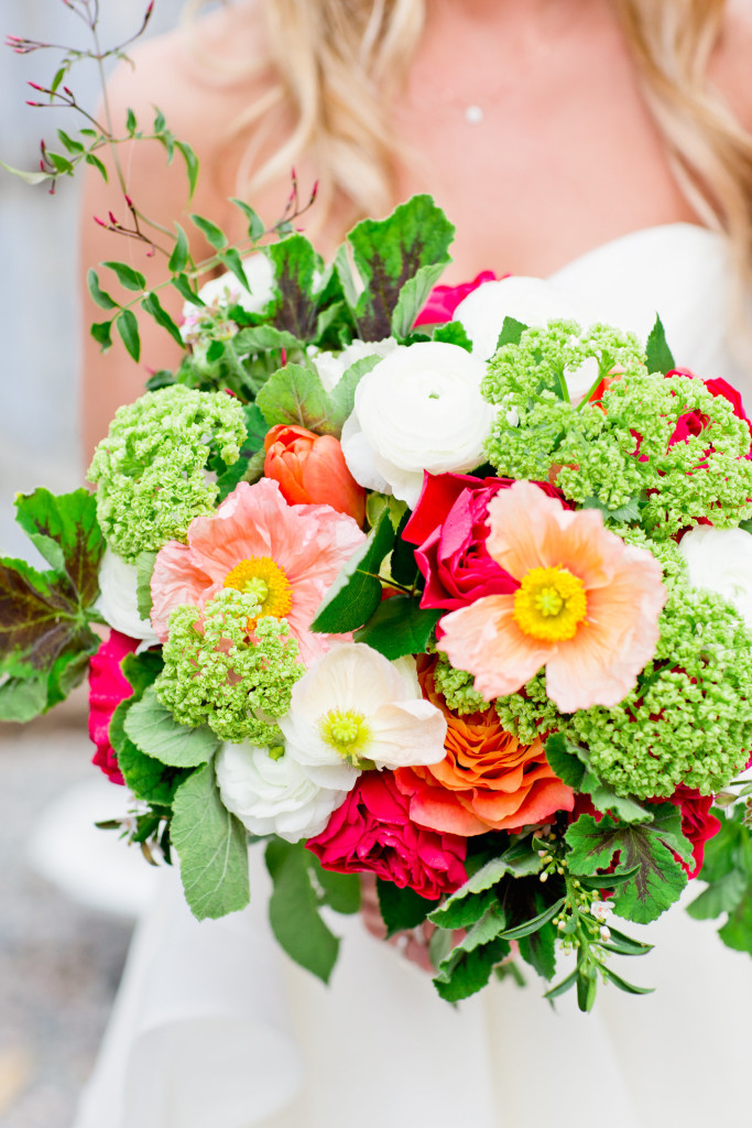 Spring wedding bouquet with poppies, snowball viburnum, garden roses, ranunculus, tulips, jasmine, scented geranium.