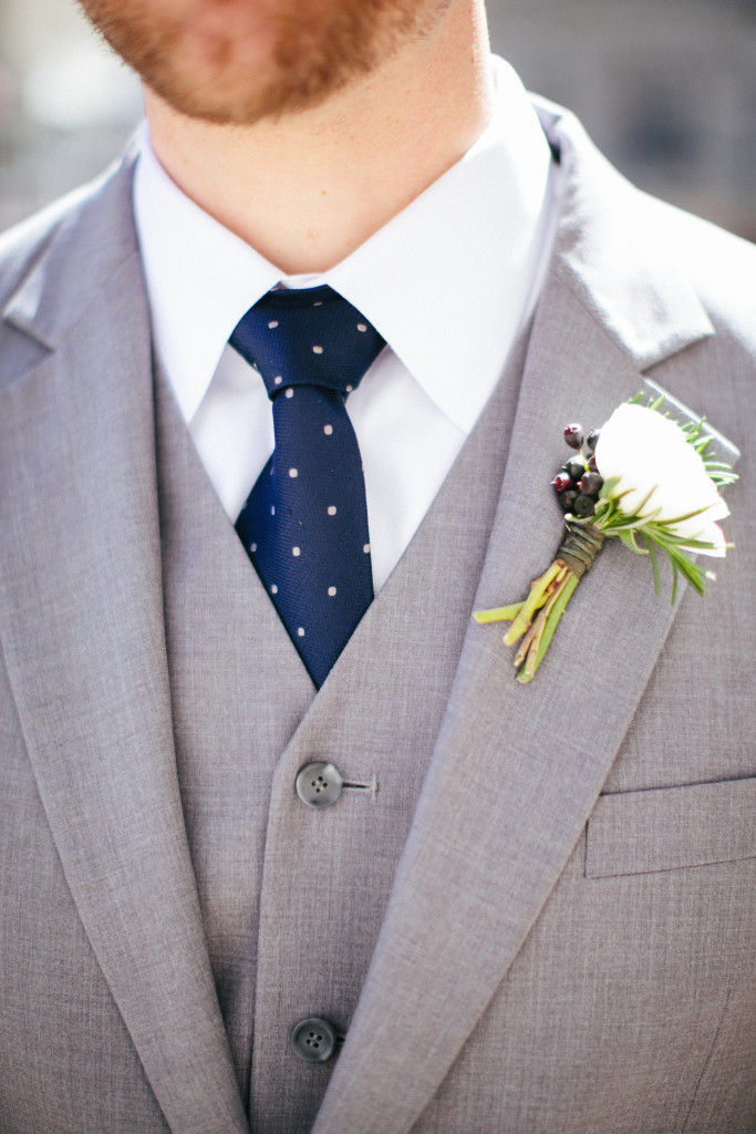 Spring boutonniere with ranunculus and berries.