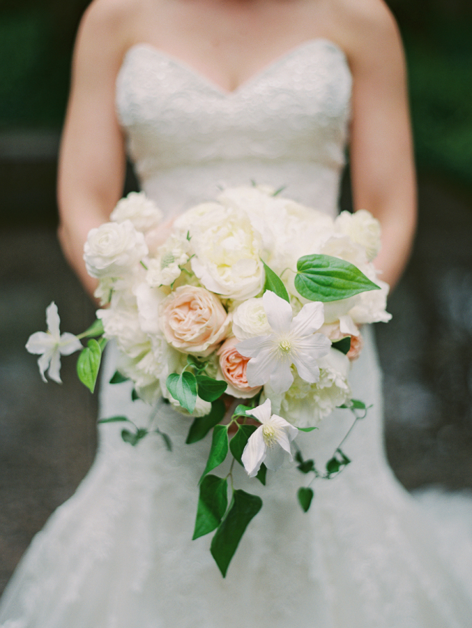 spring wedding bouquet with peonies, ranunculus, clematis
