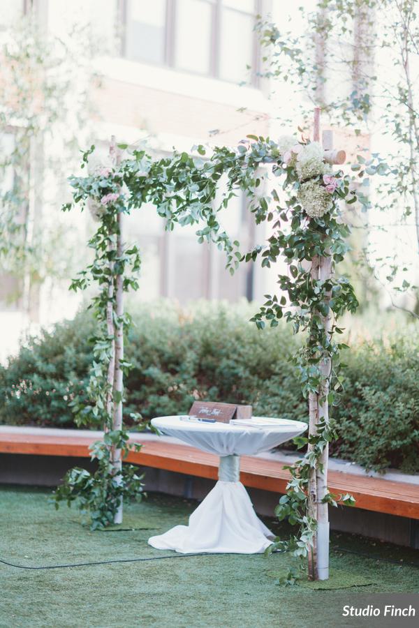 Birch wedding arch, sprawling vines, hydrangea at Greenhouse Loft in Chicago
