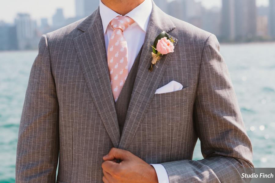 Pinstripe suit with blush boutonniere.