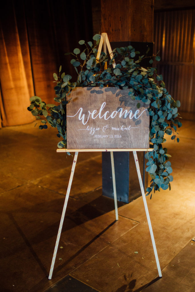 Flowers by Pollen. Photography by Tim Tab Studios. Wedding welcome sign with silver dollar eucalyptus garland.