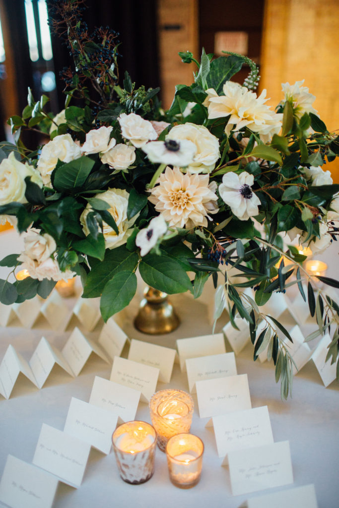 Flowers by Pollen. Photography by Tim Tab Studios. Escort card table centerpiece with panda anemone, cafe au lait dahlias, white majolika.
