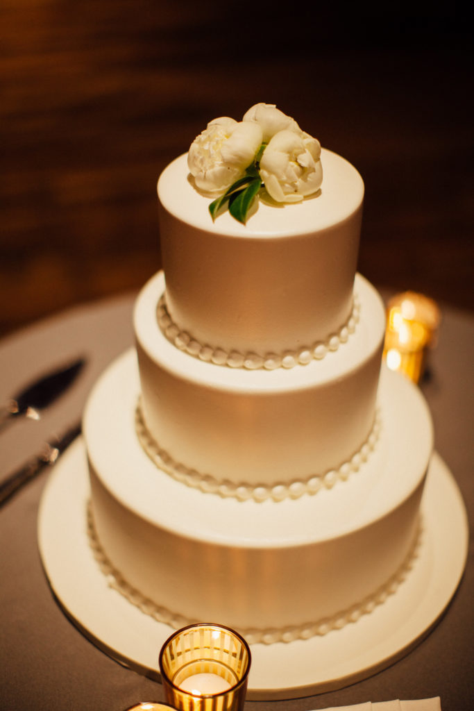 Flowers by Pollen. Photography by Tim Tab Studios. Wedding cake with peonies on top.