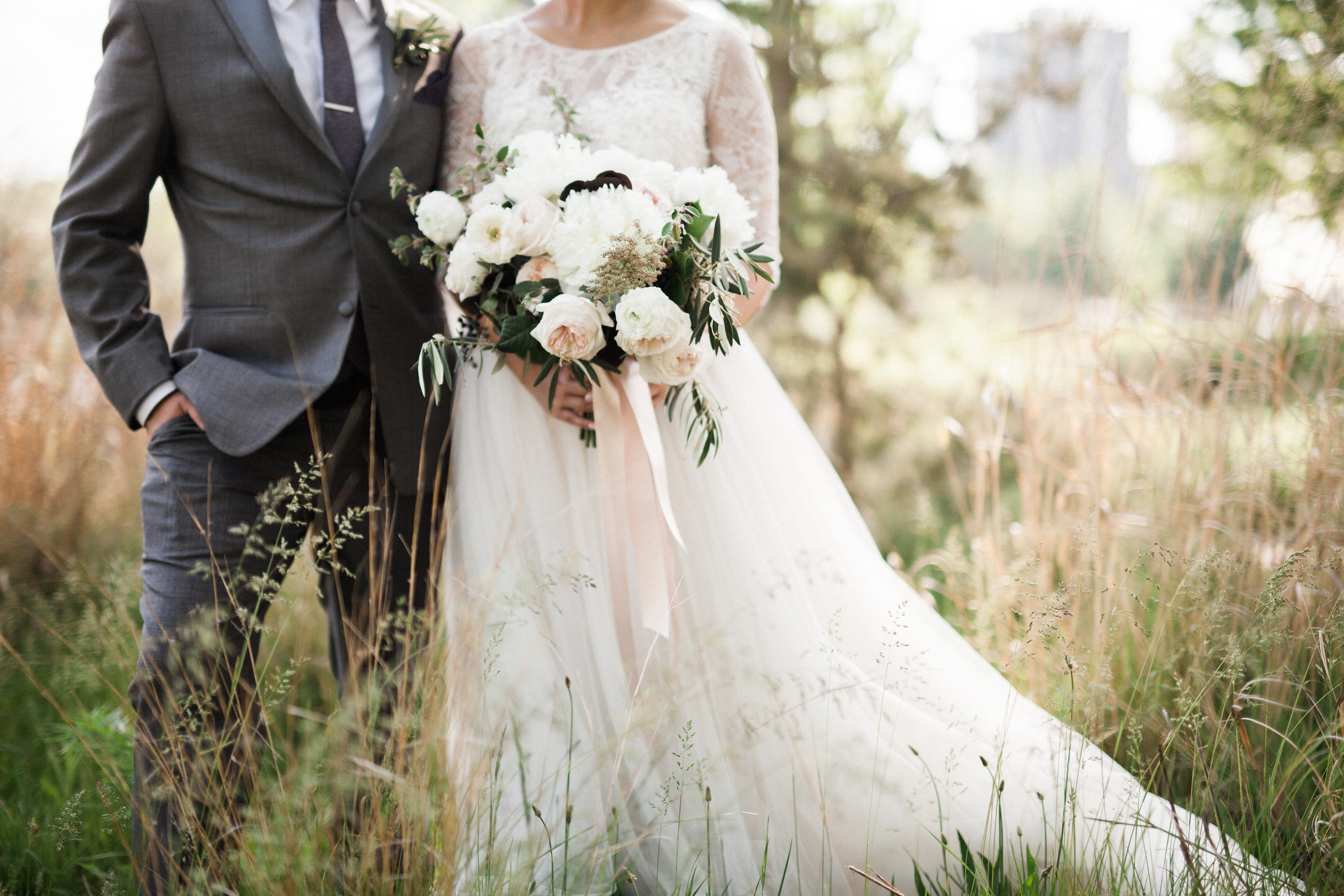 bride and groom with spring bridal bouquet in white and blush