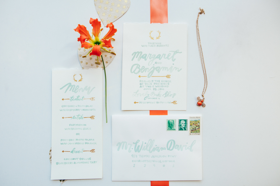 White and pale blue wedding invitations with arrows and fire lillies
