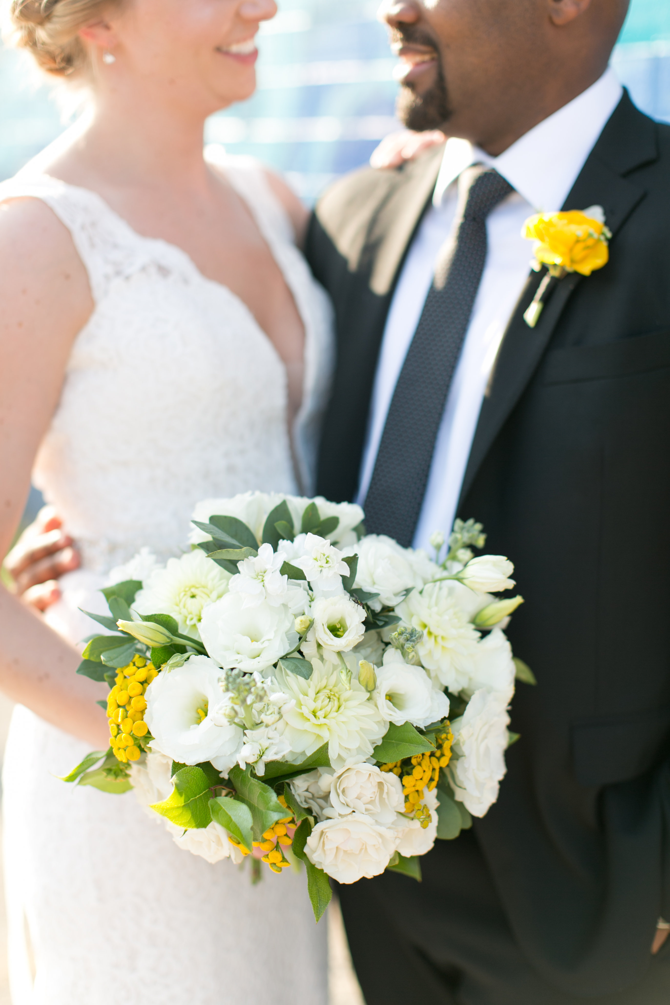 Yellow and ivory summer wedding bouquet with bride and groom
