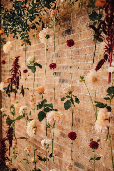 Floral curtain as suspended wedding ceremony backdrop.