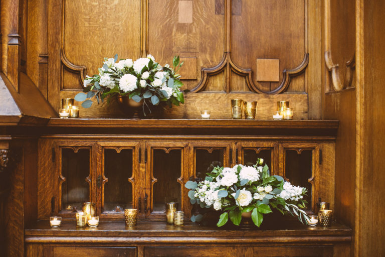 White and leafy arrangements with dahlias, garden roses, lisianthus, stock, and eucalyptus at Chicago Athletic Association for a classic fall wedding.