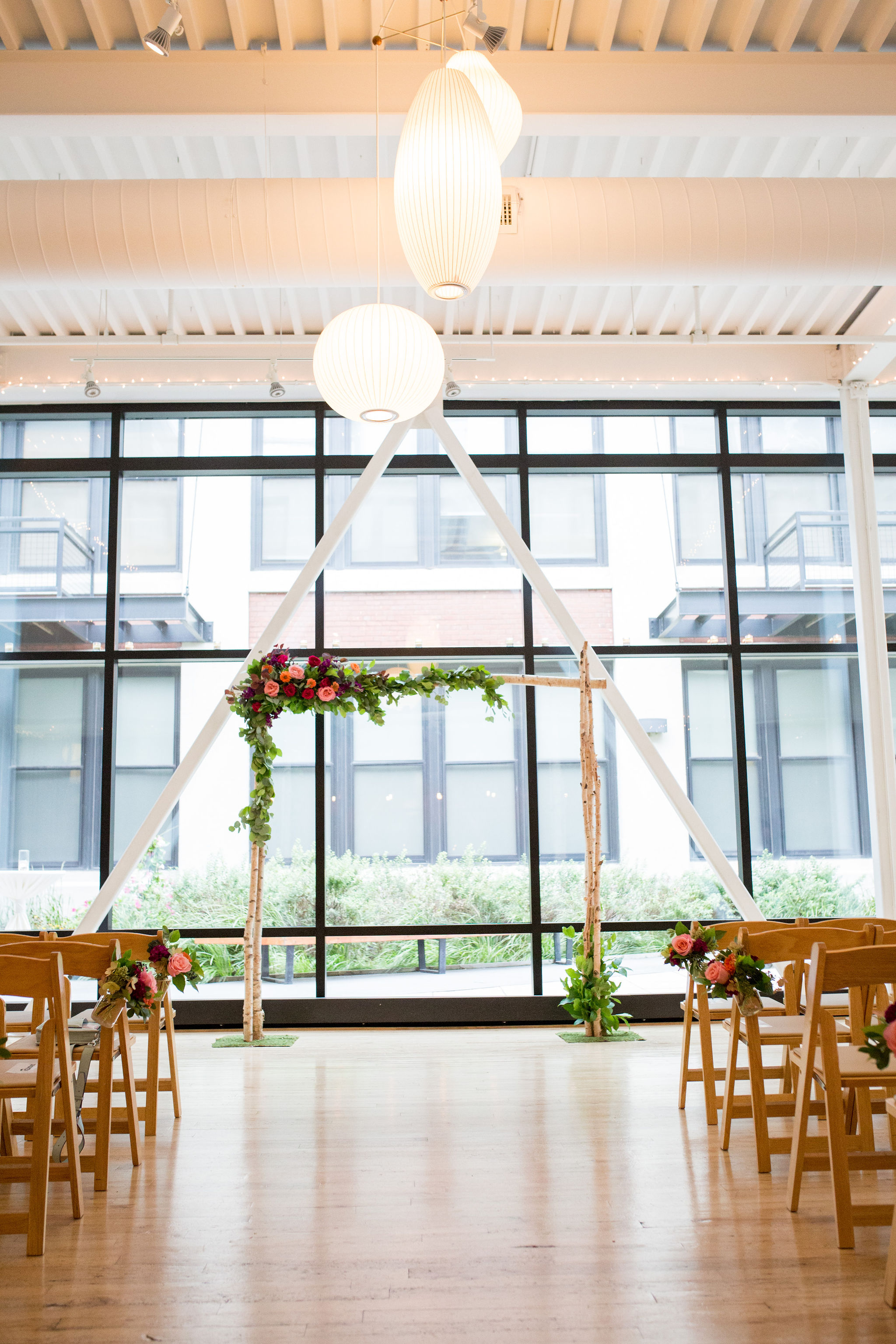 Birch arch backdrop for a wedding ceremony at Greenhouse Loft in Chicago.