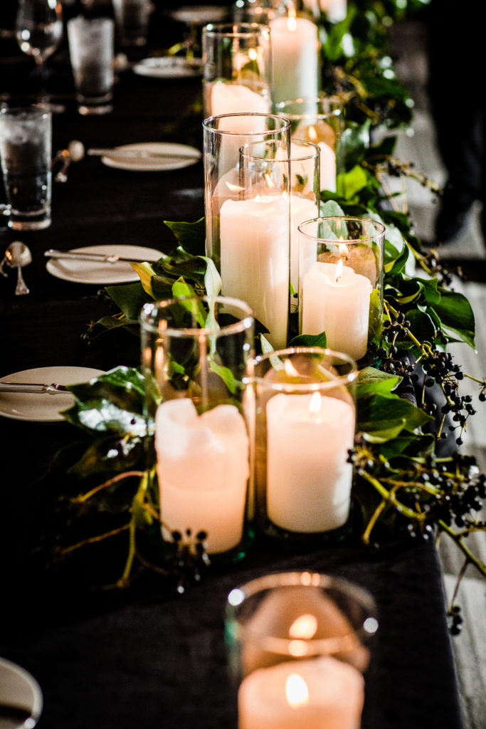Head table garland at spring wedding reception, with berried scrub ivy ad pillar candles.