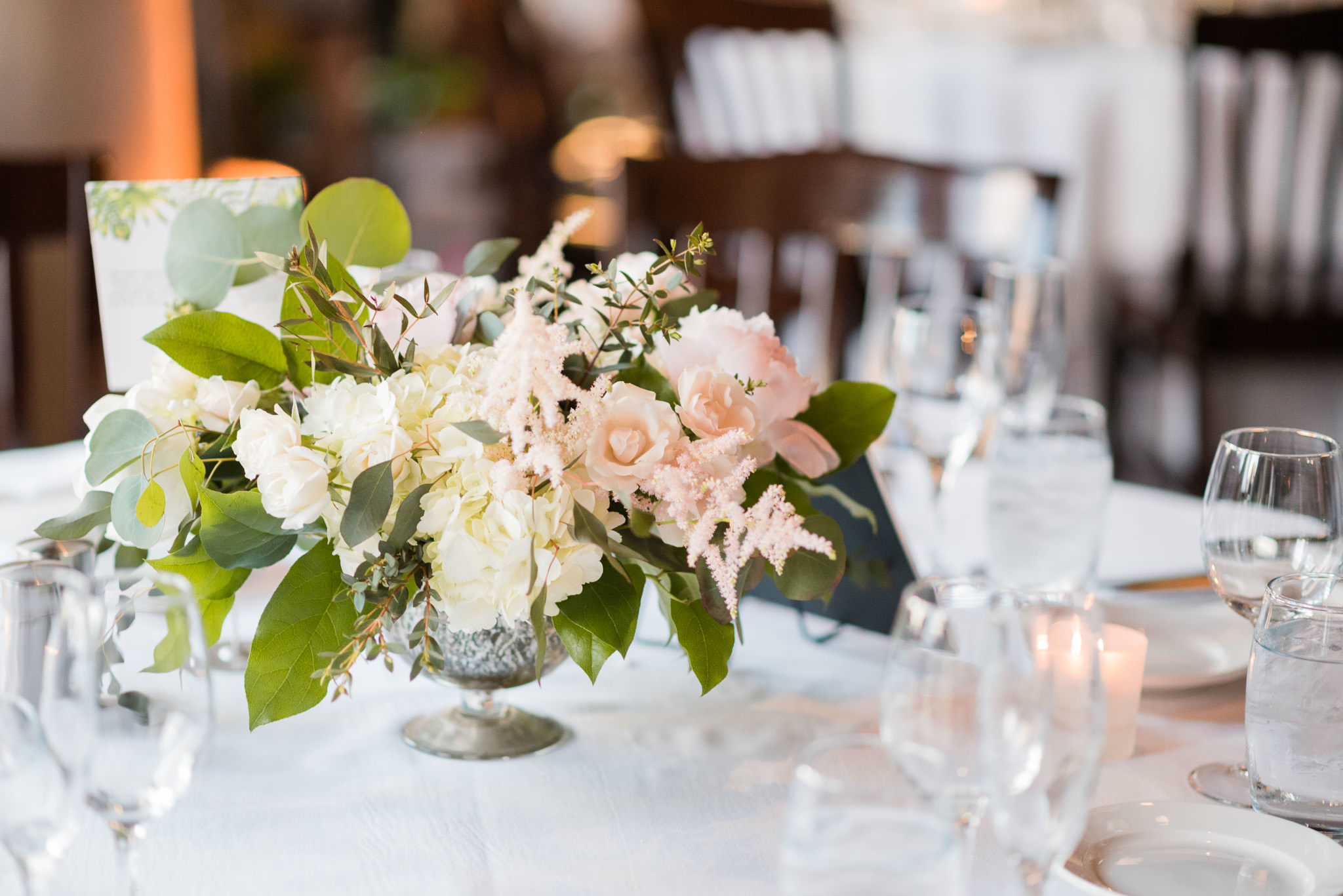River Roast Chicago spring wedding table arrangements with blush astible, stock, peonies, and eucalyptus. 