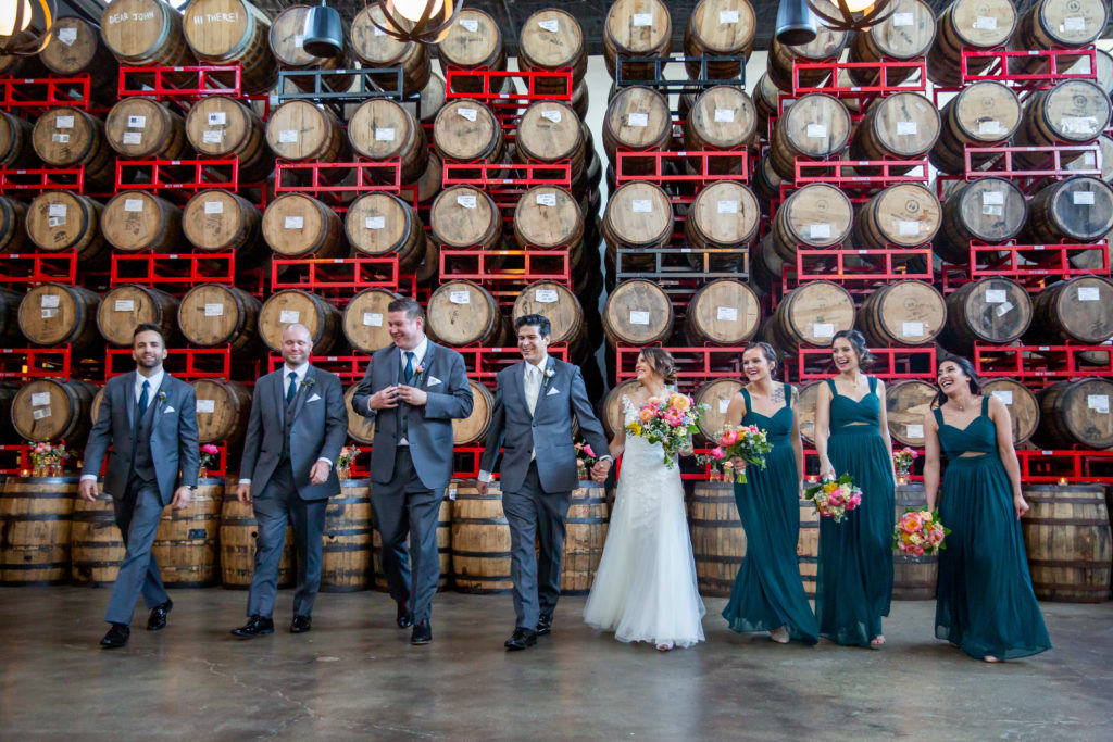 Revolution Brewing Chicago spring wedding party with vivid, garden-style bouquets of magenta peonies, poppies, yarrow, ranunculus, and astilbe.