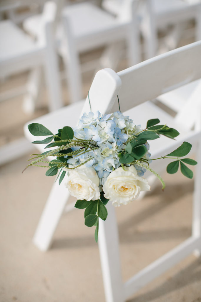 Chair swag on white chair for outdoor July wedding at Adler Planetarium with blue hydrangea and ivory garden roses.