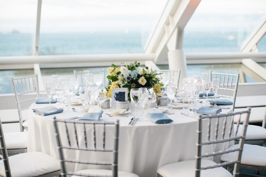 Adler Planetarium summer wedding in white and silver with blue, pale yellow, and ivory arrangements of hydrangea, thistle, garden roses, and stock and celestial details.