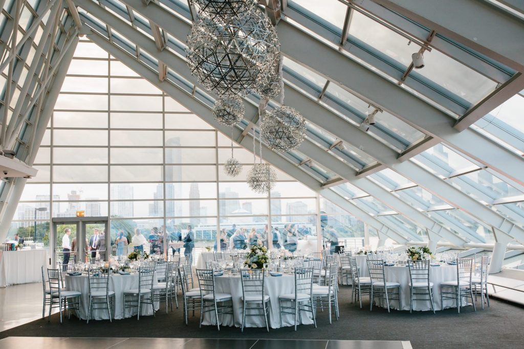 Adler Planetarium summer wedding in white and silver with blue, pale yellow, and ivory arrangements of hydrangea, thistle, garden roses, and stock. 
