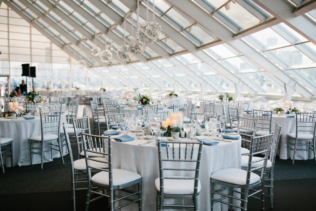 Adler Planetarium summer wedding in white and silver with blue, pale yellow, and ivory arrangements of hydrangea, thistle, garden roses, and stock and celestial details.