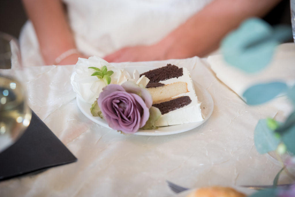 Chocolate and vanilla slice of cake with dusty purple and ivory garden roses to finish off a spring wedding. 