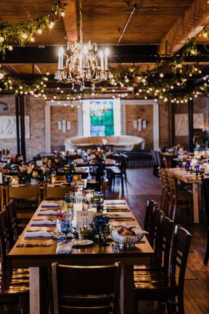 This couple’s Salvage One reception was absolutely captivating. Some of our favorite parts: the glowing lights, unique vintage tableware, the floating floral centerpiece above the sweetheart table, and the floating floral hoops over their wedding cake. 