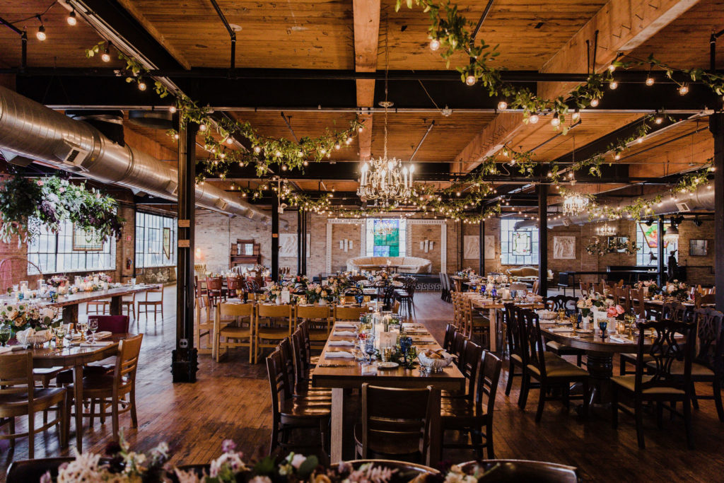This couple’s Salvage One reception was absolutely captivating. Some of our favorite parts: the glowing lights, unique vintage tableware, the floating floral centerpiece above the sweetheart table, and the floating floral hoops over their wedding cake. 